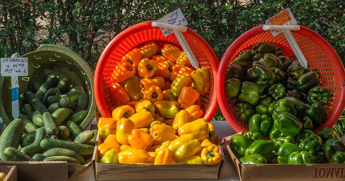 Peppers and cucumbers at a farmers market